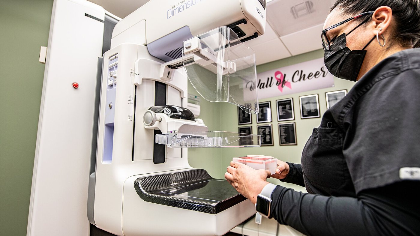 A radiology technician prepares a modern 3D mammography (breast tomosynthesis) unit at a women's imaging centre in Gonzales, Texas.